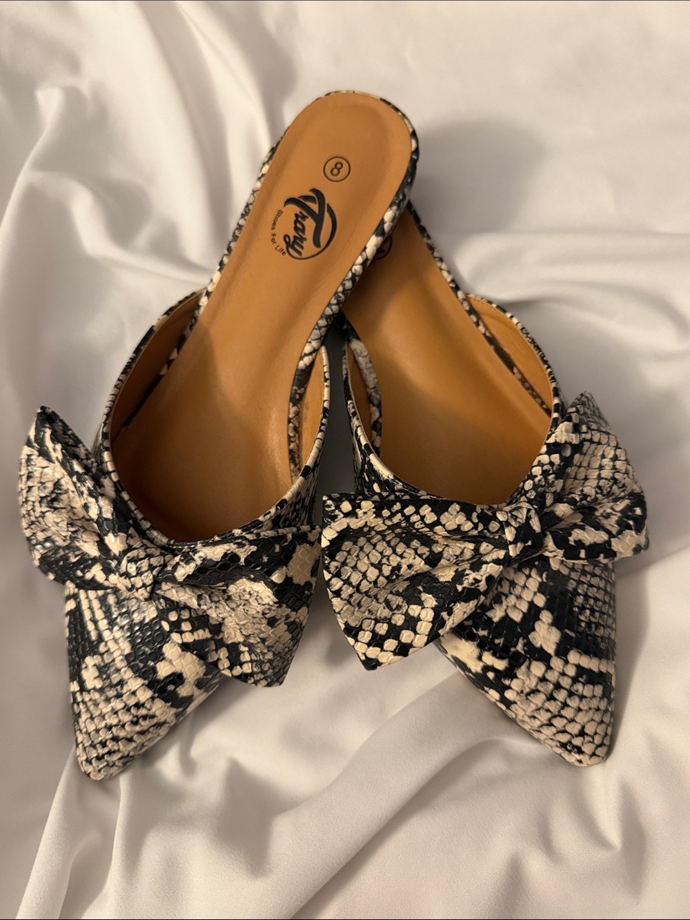 Trary Black and Cream Snakeskin Bow Pointed Mules